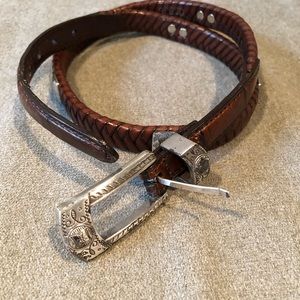 Leather belt with  silver buckle and details.